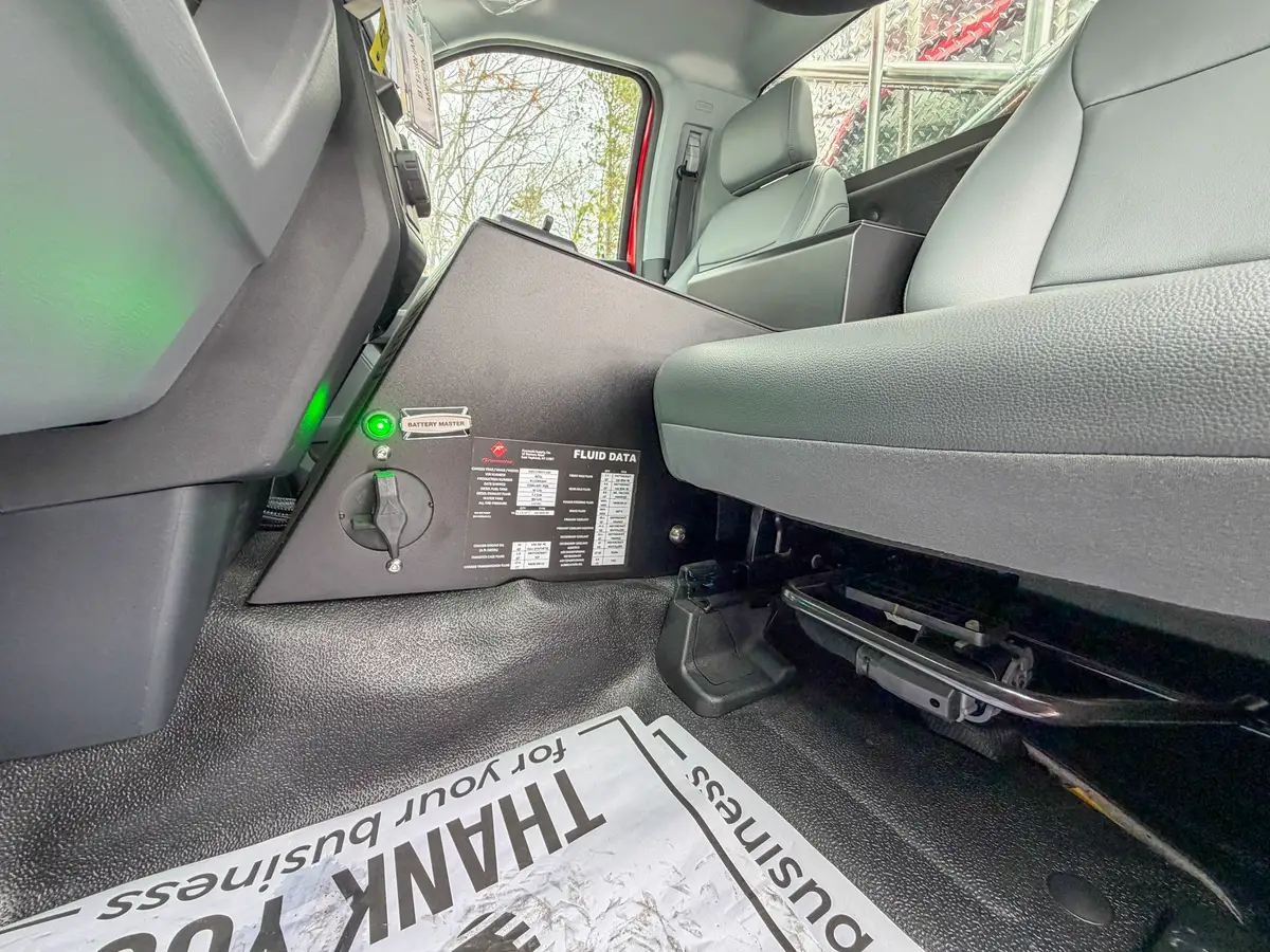 Rear cabin floor area with control box and wiring access panel.